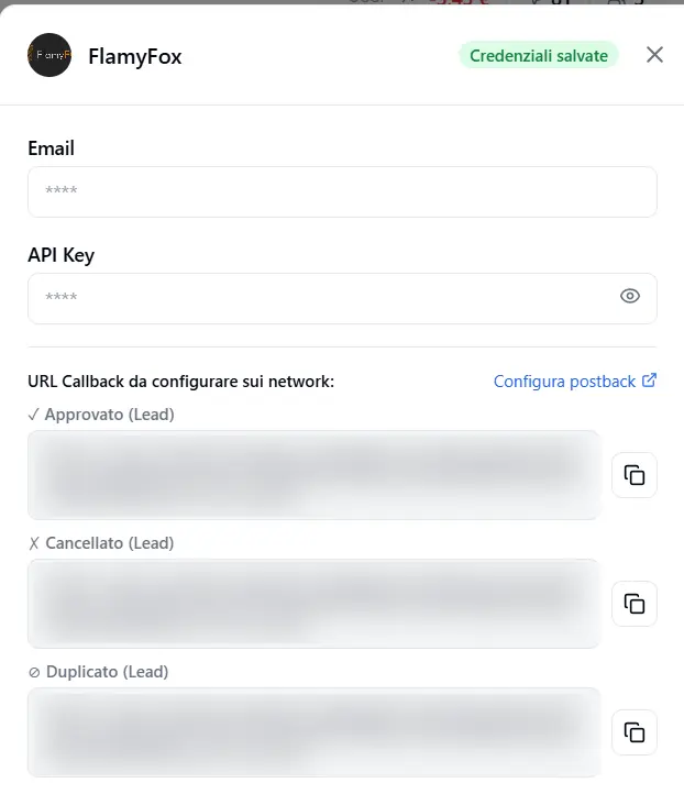 La scheda FlamyFox: in alto Email e API Key, sotto i tre URL di callback (approvato/annullato/duplicato) da incollare nel pannello